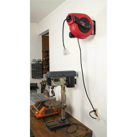 Lincoln Workhorse Heavy Duty 60 Foot Tri Tap Electric Power Cord Reel installed on wall above workbench, red and black