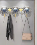 Heavy Duty Five Hook Wall Mount Coat Rack Sleek Steel Storage Bar For Zero Clutter Entryway with three hooks holding a scarf and a bag.