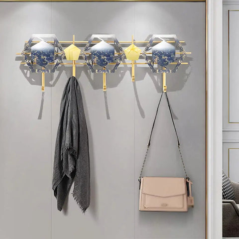 Heavy Duty Five Hook Wall Mount Coat Rack Sleek Steel Storage Bar For Zero Clutter Entryway with three hooks holding a scarf and a bag.