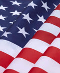 Close-up of 2x3 Indoor Outdoor US Flag Made From Polyester Nylon With Double Stitch Edges And Brass Grommets, showing vibrant stars and stripes.