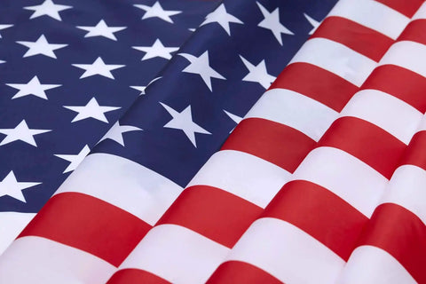 Close-up of 2x3 Indoor Outdoor US Flag Made From Polyester Nylon With Double Stitch Edges And Brass Grommets, showing vibrant stars and stripes.