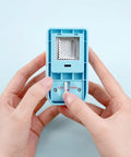 Hands holding a blue Rectangular Postage Stamp Punch 1x0.8 Inch With Scalloped Edge, showing lock and unlock buttons, ideal for crafting.