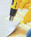 Dual Temp Heat Gun Kit With 750 Degrees F And 1000 Degrees F, Three Nozzles Included, DIY-Friendly, used for softening paint on floor.