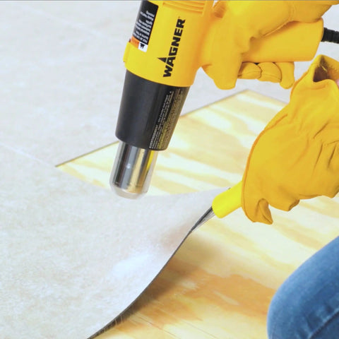 Dual Temp Heat Gun Kit With 750 Degrees F And 1000 Degrees F, Three Nozzles Included, DIY-Friendly, used for softening paint on floor.