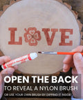 Hands using a wood burning marker kit for adults, no soldering needed, 2 in 1 pyrography tool with brush tip on a wooden disc with 'LOVE' design