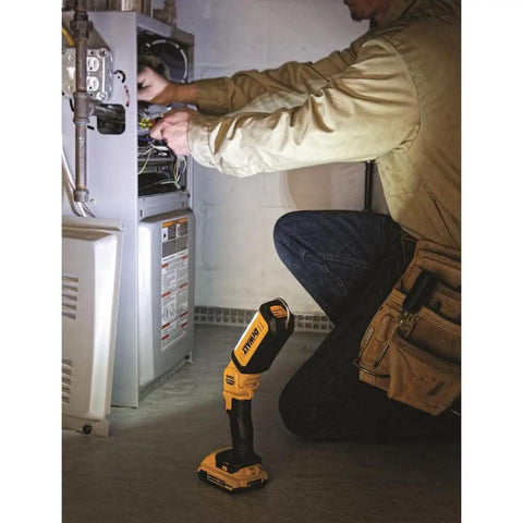 Person using 20V Max LED Work Light Bare Tool Only With Pivoting Head No Fuss Setup Three Bright LEDs 1000 Lumens High 300 Lumens Low Rechargeable Jobsite Light For Dark Work Surfaces while fixing furnace