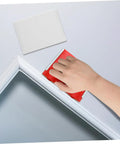 Hand using two pack paint edger pad refills for deck stain and wall painting, smooth edging on trim corner with elastic edger tool.