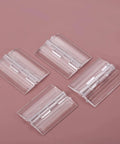 Set Of Four Clear Acrylic Folding Hinges 45x35mm Mini Hinge Hardware on pink background