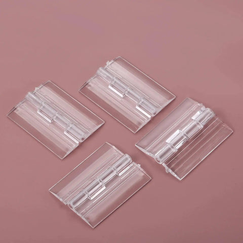 Set Of Four Clear Acrylic Folding Hinges 45x35mm Mini Hinge Hardware on pink background