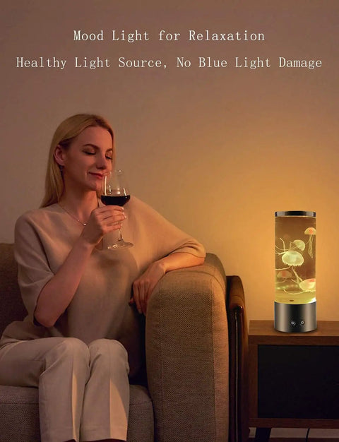 Woman relaxing with a Jellyfish Lamp With 16 Color Changing Lights And Remote Control on a side table, ambient night lighting.