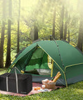 Black Ultra Spacious 96L Travel Duffle Bag next to green tent in forest setting, emphasizing camping use.