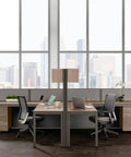 Dual L Shaped Office Cubicle Workstation With Roll Along File Cabinet And Chill Gray Desktop Layout For Squad Collaboration and hassle free daily workflow management, featuring two desks and large windows.