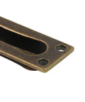 Close-up of antique brass finger pull from a 2 Pack Recessed Door Edge Pulls For Sliding Doors, with screws, 85x31x13 mm size
