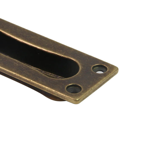 Close-up of antique brass finger pull from a 2 Pack Recessed Door Edge Pulls For Sliding Doors, with screws, 85x31x13 mm size