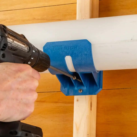 Heavy Duty Dust Hose Support Cradles For 4 Inch Shop Vac Tubing, blue ABS mounting bracket securing a PVC pipe to the wall.