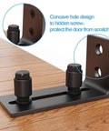 Black Floor Guide And Bottom Wall Guide Set For Barn Doors With Flush Design Flat Bottom Stay Roller Two Pack Heavy Duty Cast Iron Rust Resistant Powder Coat 5 Mm Thick 4.72 In Length 5.26 In Height 2.05 In Wide, showing a side view with concave hole design.