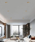 Slick Brass Led Recessed Lighting Kit 9 Pack Baffle Trim Ceiling Spots illuminating a stylish modern living room.
