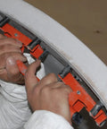 Hands using Flexible Sanding Block Flexisander for curved surfaces with a sturdy fastening system, ideal for auto body repair.