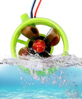 12V-24V 15A Brushless Underwater Thruster With 4 Blade Propeller submerged in water, green casing, suitable for RC Boats and ROVs.