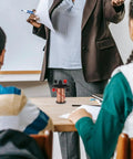 Teacher demonstrating Hands On Electromagnetic Induction Solenoid Kit For High School Physics With Primary And Secondary Coils.