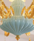 Next Level Modern Chandelier With Bold Adjustable Design And Sparkling Crystal Glass Accents Bright 15 Light Led Ceiling Pendant Gold and blue zinc finish close-up view.