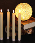 Flameless Taper Candles Set Of 8 With Remote And Timer, Real Wax 3D Wick Battery Operated Ivory Candles on books, cozy ambience