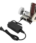 Smooth Operator Mini Belt Sander And Bench Grinder With Variable Speed Dial Forward Reverse Switch And Angled Table For No Sweat Woodworking And Fast Metal Buffing On Any Bench, compact design with power adapter.