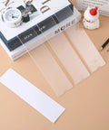 Clear 8 Inch Acrylic Name Plate Holder 2x8 Inch Wall Sign Display Pack of 20 with Sticky Tape on a desk setup
