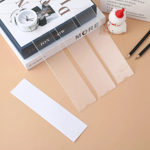 Clear 8 Inch Acrylic Name Plate Holder 2x8 Inch Wall Sign Display Pack of 20 with Sticky Tape on a desk setup