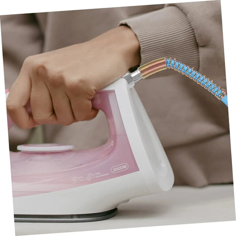 Close-up of a person using an iron with a High Temperature Steam Hose Replacement Tube For Steam Irons, Heavy Duty High Pressure Design.