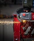 Norton 4-1/2-inch cut-off wheel in use on an angle grinder; sparks fly while cutting metal.