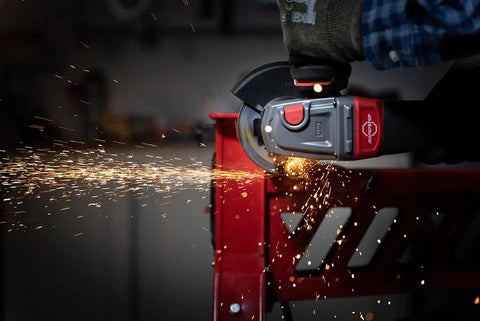 Norton 4-1/2-inch cut-off wheel in use on an angle grinder; sparks fly while cutting metal.