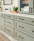 Malin Collection Cabinet Pulls in Warm Brass Finish on kitchen cabinets, 5 1/16 inch mounting centers, overall length 5 3/4 inches.