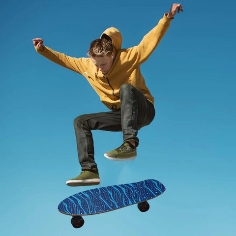 Skater mid-jump using Electric Blue Wave Pattern Grippy Tape For Skateboards Waterproof Non Slip Surface 33x9 Inch Emery Top Layer