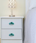 Premium Teal Marble Cabinet Cup Pulls Boasting A Killer Stone Finish and Super Slick Texture on white nightstand.