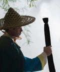 Person holding 65 Inch Sword Back Bag Cover For Katana And Shinai Travel Case With Shoulder Strap in outdoor setting