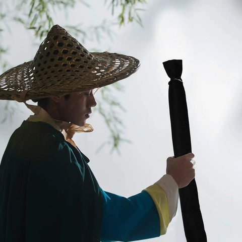 Person holding 65 Inch Sword Back Bag Cover For Katana And Shinai Travel Case With Shoulder Strap in outdoor setting