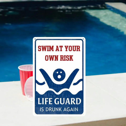 Outdoor Pool Decor Sign Swim At Your Own Risk Funny Warning Plaque displayed near a pool with cups on the deck, 8 by 12 inches metal sign.
