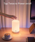 Hand reaching to turn on Smart LED Bedside Lamp With App Control, Voice Assist, and RGB Color Changing Mood Light on desk