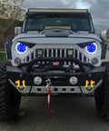 Jeep with Beefed-Up Heavy Duty Three Quarters Inch D Ring Shackles Set Forged Steel Tow And Winch Shackles Four Point Seven Five Ton Load Capacity Two Pack Off Road Recovery Gear Yellow Powder Coat With Isolators attached to front bumper.