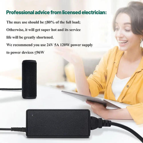 Woman sitting at desk reviewing specifications for Beefy 24V DC Power Adapter 5A Switching Power Supply, device on desk.