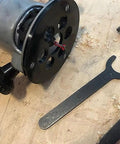 Premium Router Sub Base With Five Point Seven Five Inches And One And One Eighth Inch Opening built with a clear acrylic body, tools, and wood shavings.