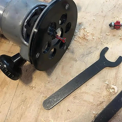 Premium Router Sub Base With Five Point Seven Five Inches And One And One Eighth Inch Opening built with a clear acrylic body, tools, and wood shavings.