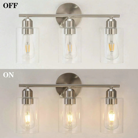 Three Light Bathroom Vanity Light In Brushed Nickel Finish With Clear Glass Shades Wall Mounted Over Mirror Hardwired Bath Light Fixtures Easy Up Or Down Installation Modern Contemporary Style, shown off and on.