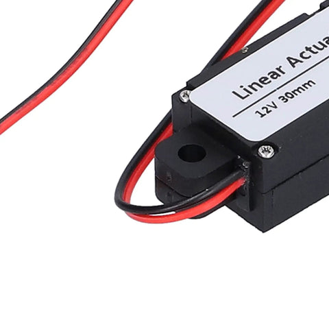 Close-up of the Compact 12V Mini Electric Linear Actuator with 30mm Stroke showing wires and label, 50N lift, for home automation projects.