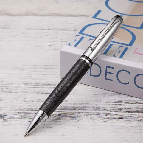 Rotary 0.5mm Ballpoint Pen Set With Leather Grip resting on a book, showcasing metal body and smooth gel ink refillable design.