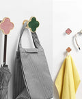 Sweet Looking Pink Clover Drawer Knobs Six Pack For Dressers And Kitchen Cupboards on hooks with umbrella and towels.