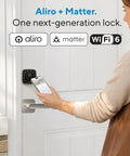 Person using smartphone to unlock Aliro next-generation WiFi smart lock on a door handle.