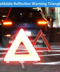 Reflective triangle from Beefed Up Roadside Emergency Kit For Cars And Trucks with a car in the background at night.