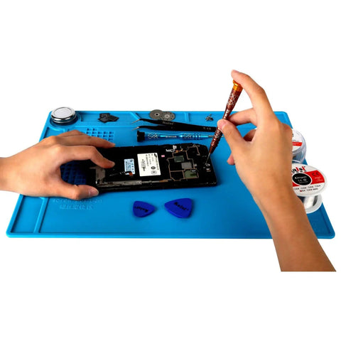 Hands repairing electronics on S-130 Heat Resistant Silicone Soldering Mat For Electronics Repair, blue with tools, 13.8 by 9.8 inch